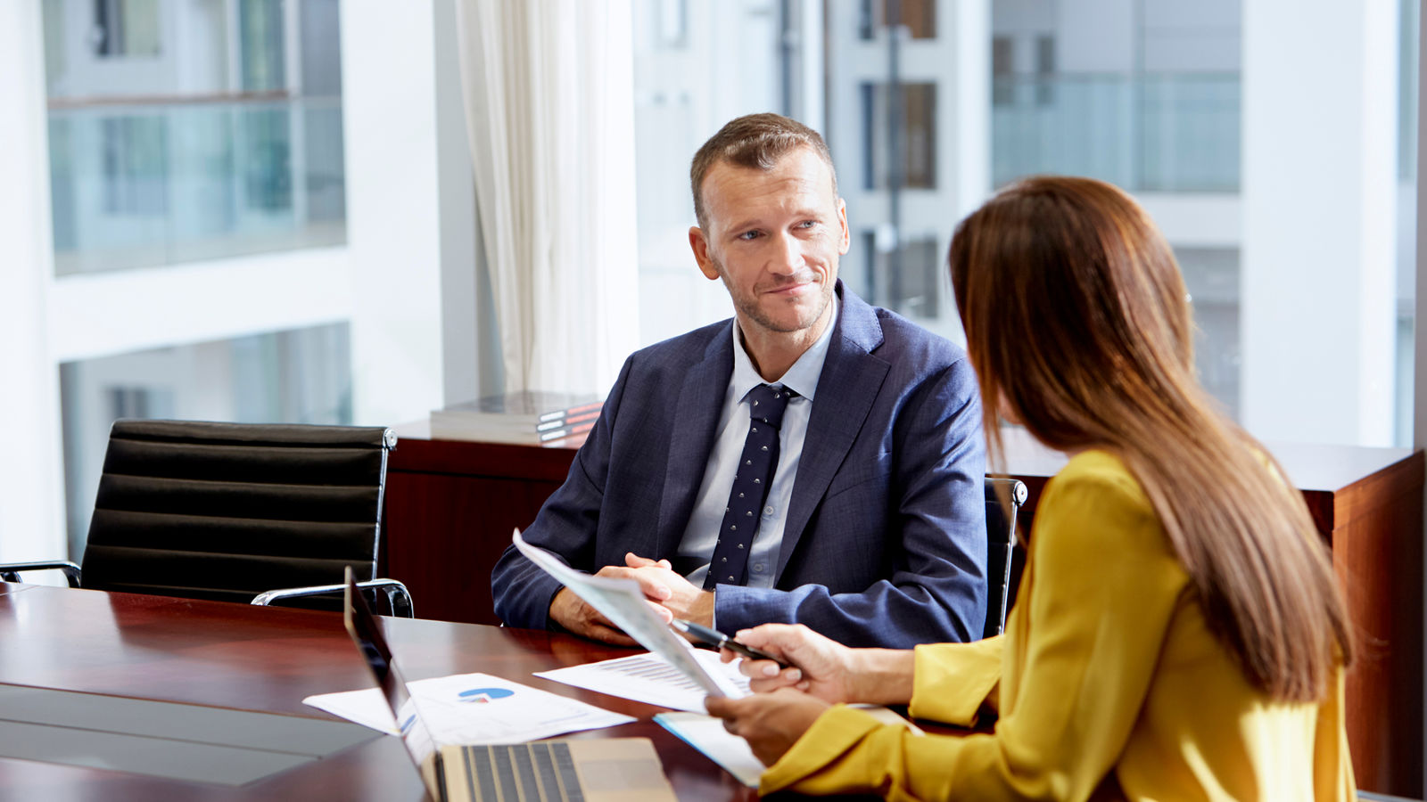 Man and woman working together by a desk