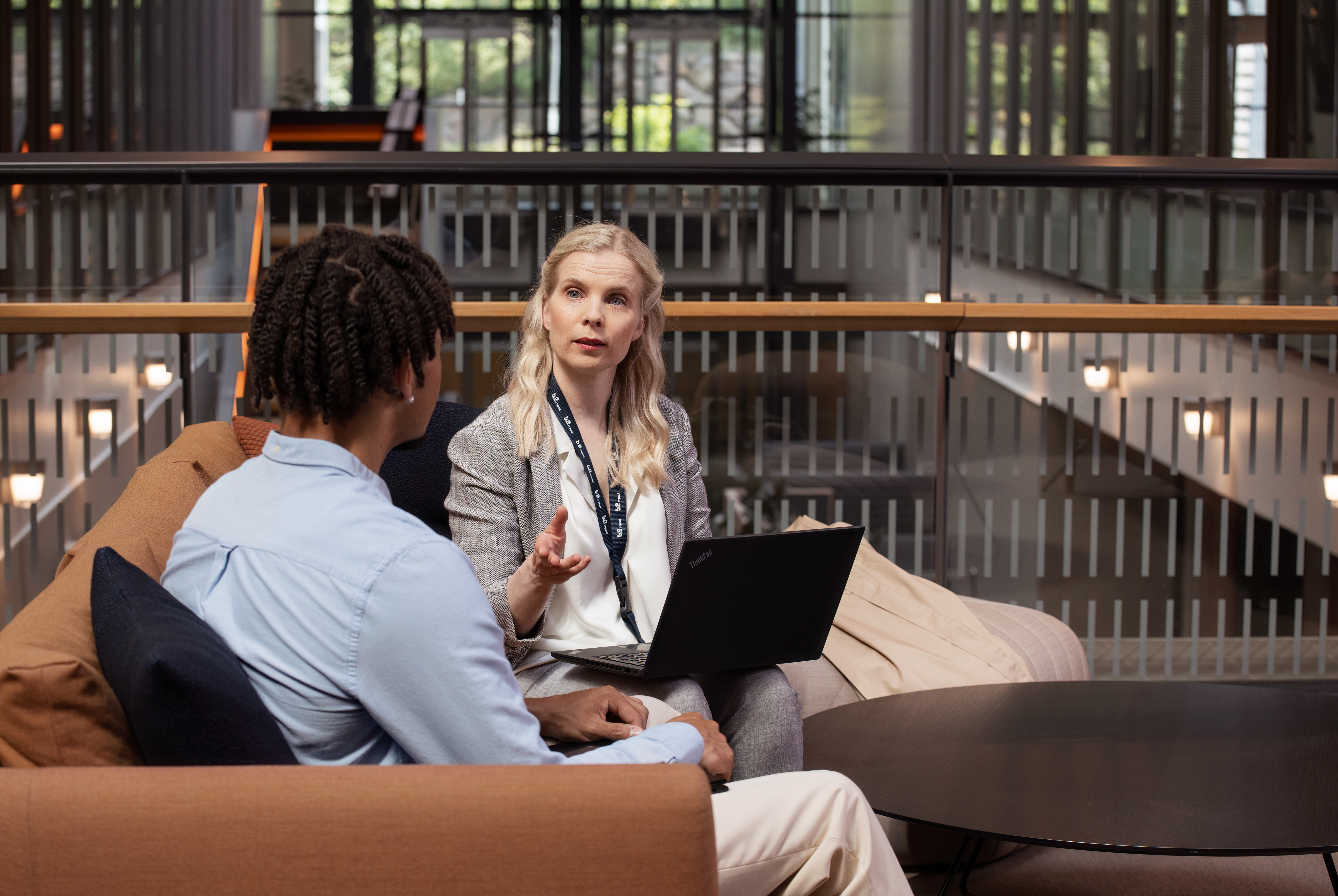 Woman and man sitting by a desk talking about some papers
