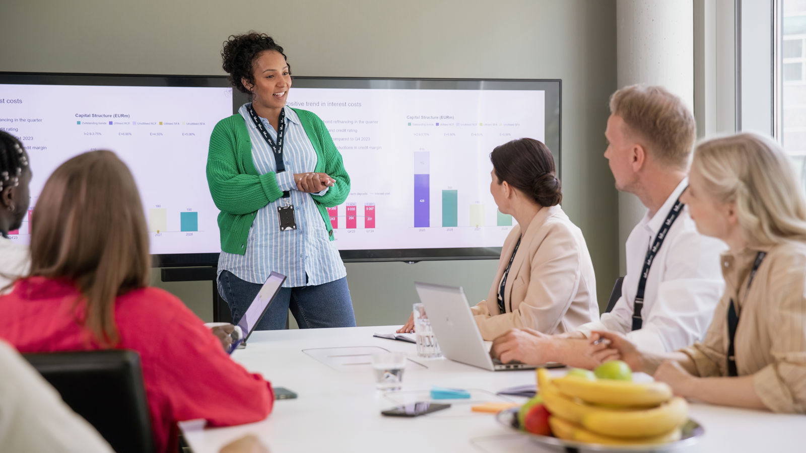 Woman presenting in a meeting with colleagues
